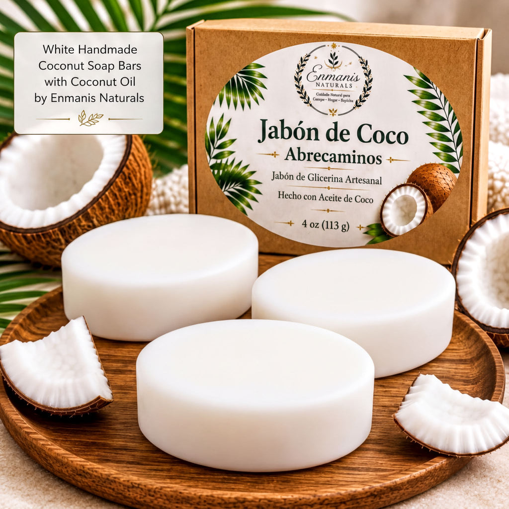 a set of white coconut soap bars with a box of the same soap bars, along with some coconut pieces and a palm leaf.
