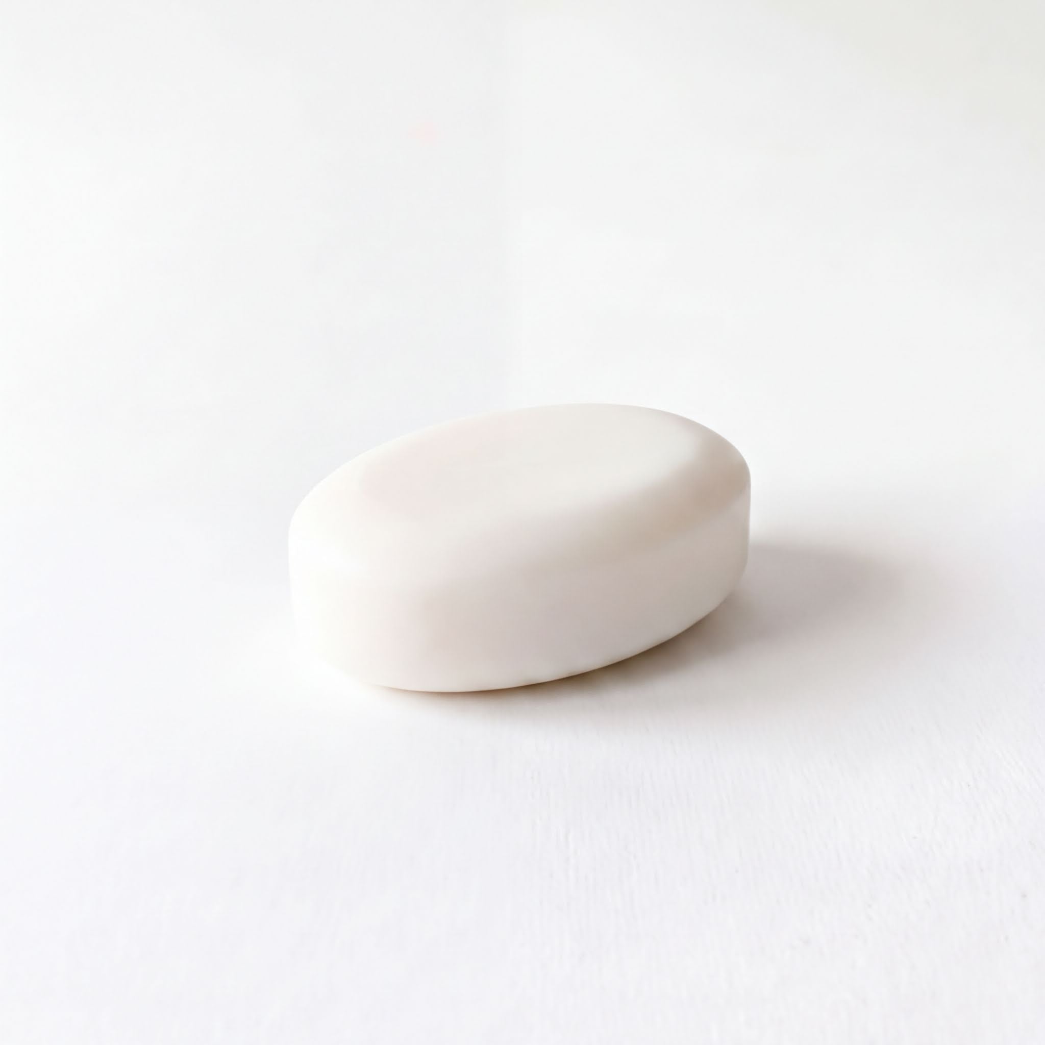 A single white oval-shaped object is shown against a plain white background.